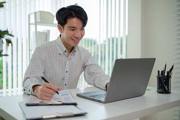istock Confident remote worker enjoys a smooth workflow in a well-lit home office. 2207589185