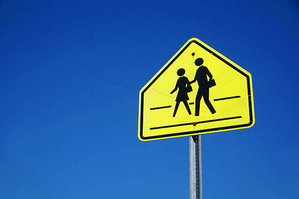 istock school crossing sign against sky 2207590487