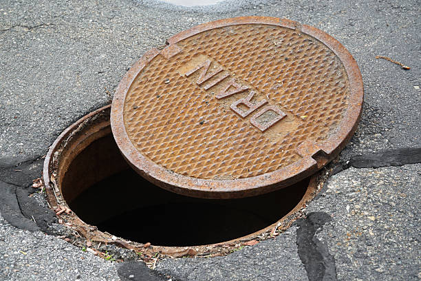 istock close up on opened rustic manhole cover on the street 2207590548