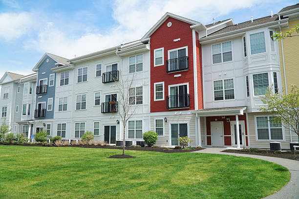 istock colorful apartment buildings and green front lawn in spring 2207590600