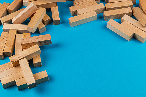 istock Wooden blocks scattered on blue surface for play 2207597645