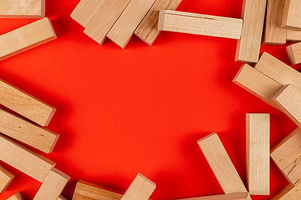istock Stacked wooden blocks on a vibrant red background 2207597686
