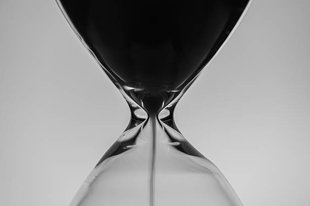 istock Minimalist hourglass with flowing sand 2207597976