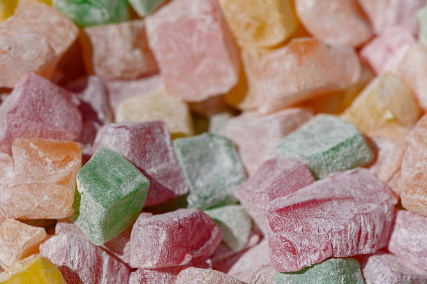 istock Colorful Turkish delight pieces scattered on a rustic wooden surface inviting sweet indulgence at a local market 2207600749