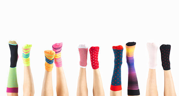 istock Women feet with various colorful socks on white background 2207601216
