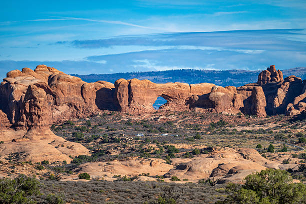 Skyline Arch, a striking sandstone formation in Arches National Park, Utah, stands tall against the vast desert landscape. This iconic natural arch, formed by erosion, offers breathtaking views of the rugged red rock terrain. A must-see destination for hikers, photographers, and nature lovers, Skyline Arch is easily accessible and provides a stunning backdrop for sunrise and sunset photography.