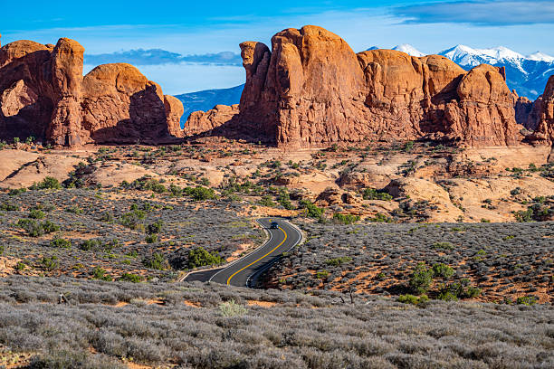 Arches National Park in Utah is home to breathtaking rock formations, set against the backdrop of the La Sal Mountains. These towering sandstone pinnacles, shaped by erosion over millions of years, create a dramatic contrast with the snow-capped peaks in the distance. A must-visit location for hikers, photographers, and nature lovers, this landscape showcases the rugged beauty of the American Southwest. Ideal for sunrise and sunset photography, this scene captures the park’s unique geological wonders.