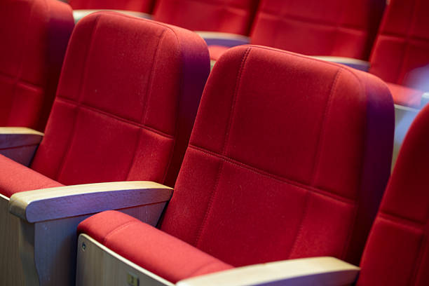istock Comfortable red theater seats arranged in a cozy setting ideal for entertainment and performances 2207602440