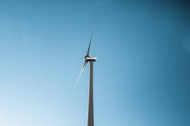 Wind turbine generating clean energy against a clear blue sky