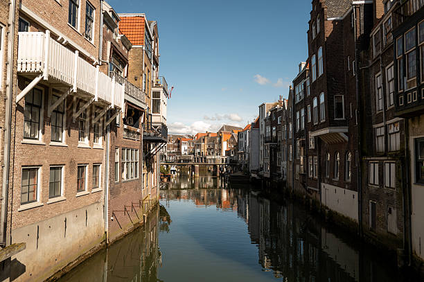 istock Canal flowing between old brick buildings in dordrecht, netherlands 2207603133