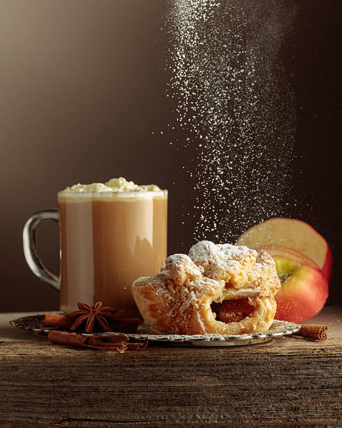 Vienna strudel and caffe latte on an old wooden table.
