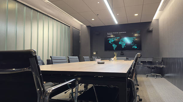 istock A modern conference room with a large screen displaying data and a world map. 2207605183