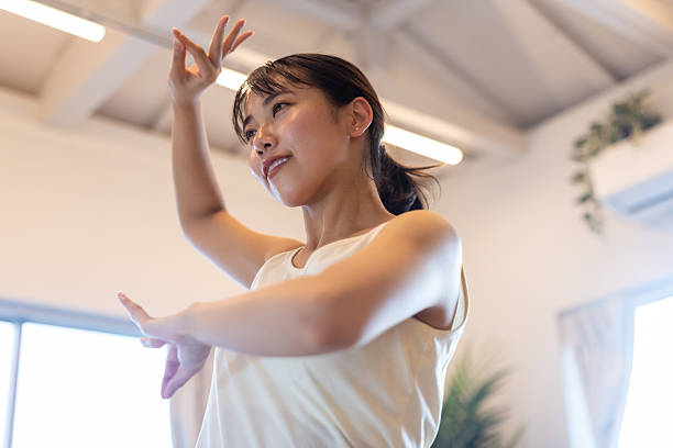 istock Young female dancer dancing in living room - low angle view 2207606672