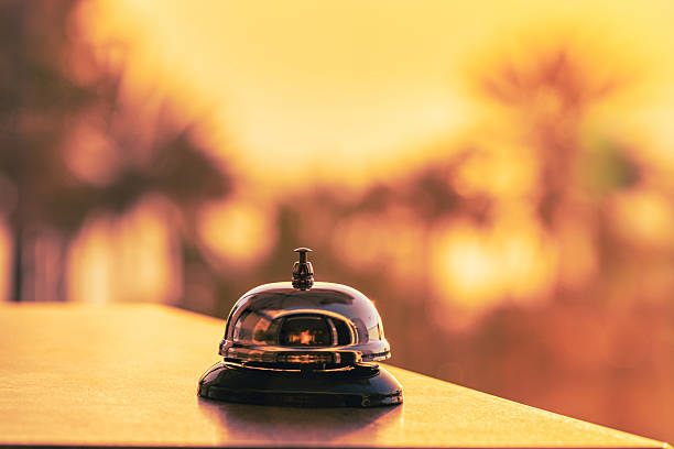 istock The desk beach cafe, restaurant with a service bell for warn that the dish is ready. Table reservation for dinner . Roof of cafe sea and palm tree view on sunset. 2207607734