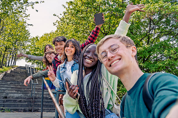 istock Happy students taking a selfie outdoors, enjoying nature and friendship 2207611491
