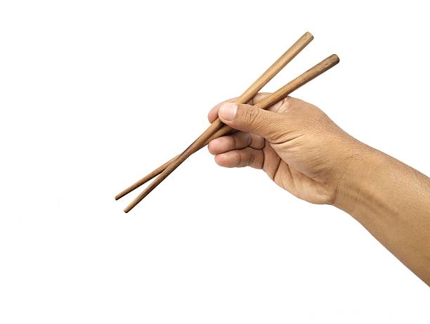istock Man hand holding chopsticks isolated on white background 2207611785