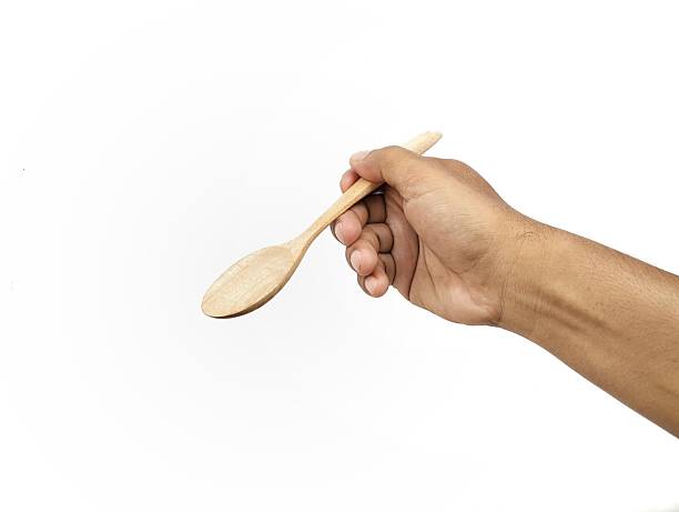 istock Man hand holding wooden spoon gesture isolated on white background 2207611786