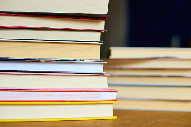 istock Stacked books on a wooden surface with a blurred background in a cozy reading space 2207611817