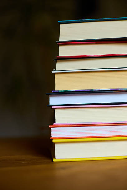 istock Stacked books on a wooden surface with a blurred background in a cozy reading space 2207611829