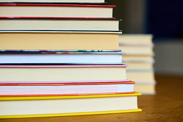 istock Stacked books on a wooden surface with a blurred background in a cozy reading space 2207611832