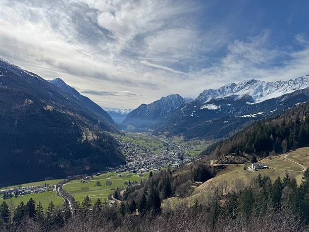 istock Idyllic Alpine Valley with Village and Mountains 2207611920