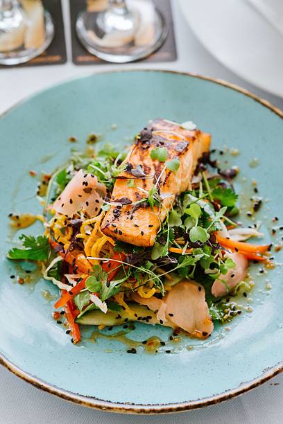 istock Grilled salmon with fresh vegetables and herbs. 2207612048