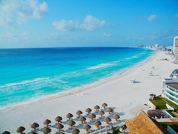 istock Beautiful ocean at Cancun Beach Mexico.  Beach Umbrellas and white sand. 2207613131