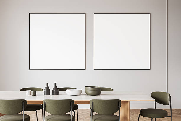 istock Minimalist dining room with two framed blank posters on light wall. 3D Rendering 2207615265