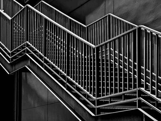 istock A set of stairs ascending a large black wall 2207615508