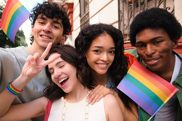 istock Young Activists Showing Rainbow Flags at LGBT Parade 2207617257