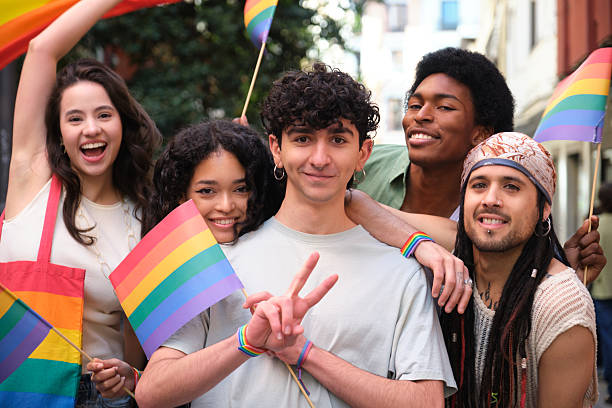 istock Young activists showing rainbow flags at pride parade celebrating lgbtq+ community 2207618416