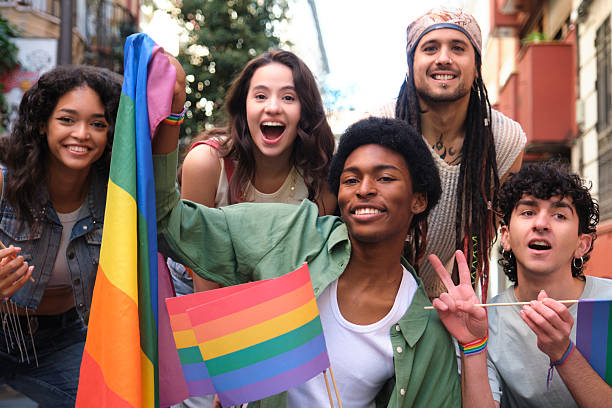 istock Young activists showing rainbow flags at a LGBT pride parade 2207618705