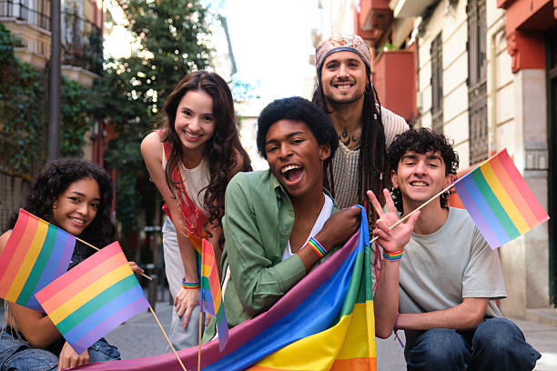 istock Young activists holding rainbow flag and celebrating gay pride 2207618838