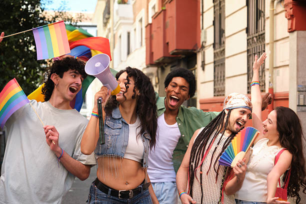 istock Young activists marching for LGBT rights with rainbow flags and megaphone 2207618977