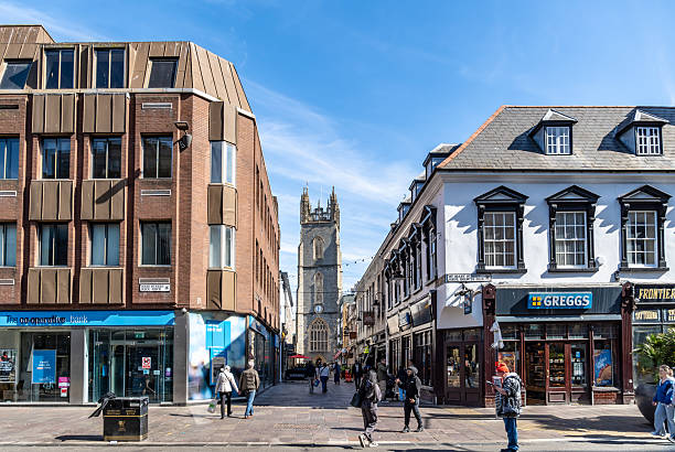 Cardiff, UK. 20 March 2025. Cardiff city centre with church in background and a Greggs store.