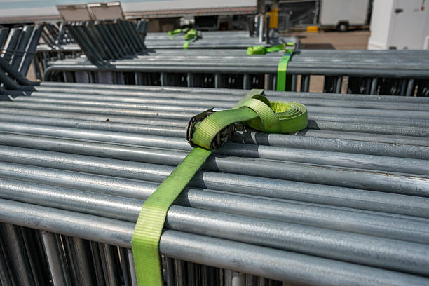Tied up silver-colored metal barricades in groups.