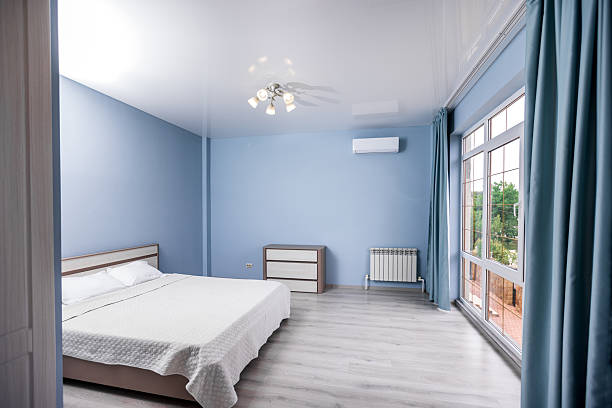 istock A bedroom with a white bed and blue curtains 2207624152