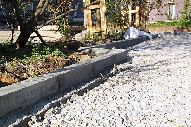 istock Concrete blocks forming a retaining wall. Stacked concrete blocks for road construction. Gray Interlocking asphalt system. Textured concrete blocks in structure. Close up of concrete retaining wall 2207627670