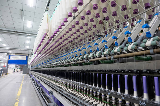 istock Modern workshop equipment in a textile factory, neatly arranged bobbins 2207629354