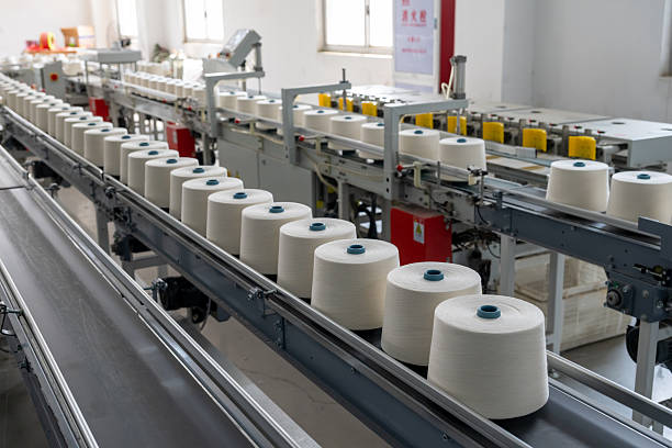 istock Textile factory neatly sewing spools of thread 2207629482