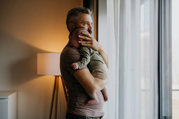 istock Father comforting his crying baby son. 2207631205