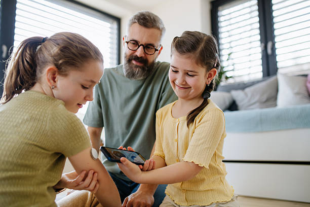 Diabetic girl with a CGM sensor on her arm. stock photo