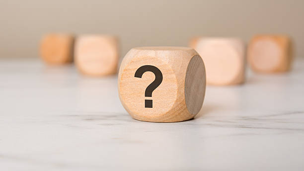 istock Wooden cube with a question mark symbolizing curiosity, mystery, and decision-making concepts. 2207633496