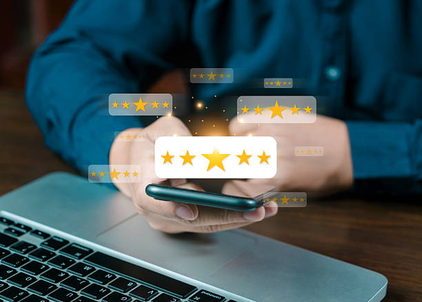 istock Online customer satisfaction survey service, The customer is hand-press on the smartphone with gold five-star rating feedback icon and pressing excellent rank to give the best score point for review 2207633854