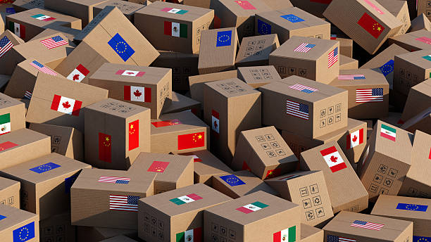 istock Chaotic pile of cardboard boxes with flags – Symbolizing Trade Tariffs and Global Trade Challenges 2207636051