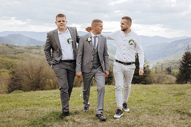 istock Three men dressed in suits and ties walking on a grassy field 2207636523