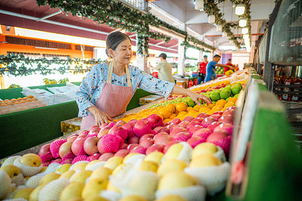 istock Hands-on Entrepreneur: Senior Woman Running a Fruit Stand 2207637128