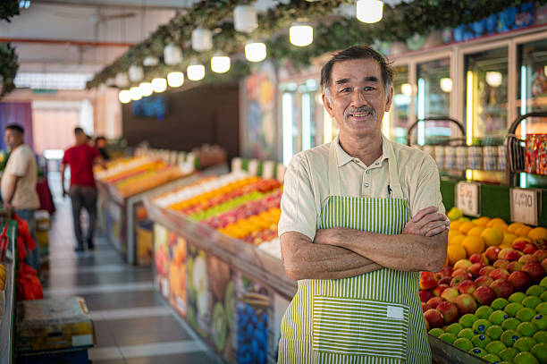 istock Smiling Success: Senior Asian Man Running His Fruit Stand Business 2207637329