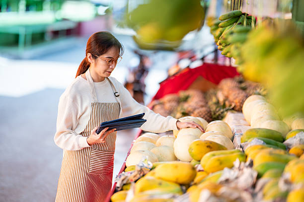 istock Modern Entrepreneurship: Fruit Stand Owner Using Digital Tools to Track Products 2207640221