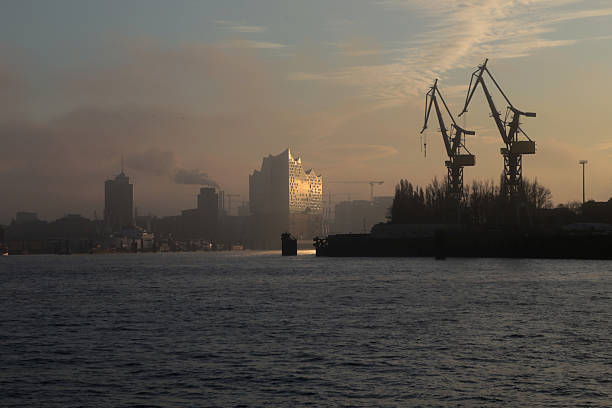 Tour with the boat in the port of Hamburg at sunrise. View at the Elbphilharmonie.